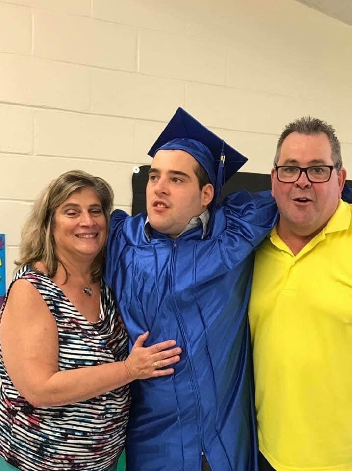 Young man and his parents at graduation